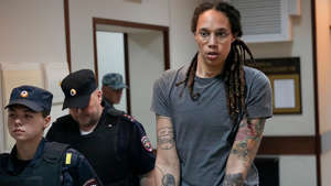 WNBA star and two-time Olympic gold medalist Brittney Griner is escorted from a courtroom ater a hearing, in Khimki just outside Moscow, Aug. 4, 2022. AP Photo/Alexander Zemlianichenko, File
