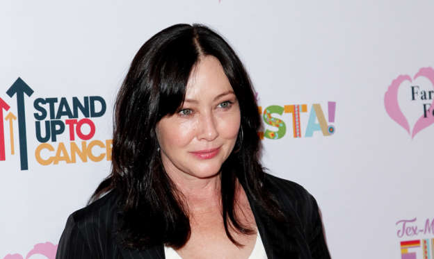 Slide 1 of 15: Shannen Doherty moved at the age of 7 to Los Angeles with her family. Quickly, Shannen dreamed of becoming an actress. Shannen Doherty would debut as an actress at the age of 10 in ‘Father Murphy’.