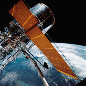 Most of the giant Hubble Space Telescope can be seen April 25, 1990 as it is suspended in space by Discovery's Remote Manipulator System (RMS) following the deployment of part of its solar panels and antennae. Images from the Hubble Space Telescope have helped unravel some of the universe's deepest mysteries since 1990.