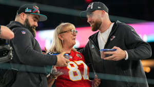 Donna Kelce greets her sons, Jason Kelce and Travis Kelce during Super Bowl Opening Night in Phoenix.