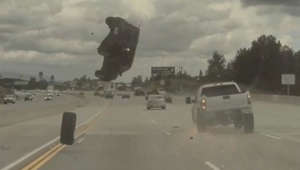 Dashcam video shows car flip mid-air on freeway after hitting a loose tire
