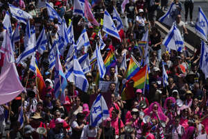 Israelis protest against Prime Minister Benjamin Netanyahu's government, in Tel Aviv, Thursday.