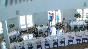 This woman had entered the ballroom before the wedding celebration as she wanted to use the restroom. On her way out, she stopped to take a picture of the staircase. Suddenly, she walked into the champagne tower while walking backward and shattered it.