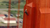 Workers wearing harnesses and helmets rappel down the San Francisco landmark looking for any signs of corrosion.