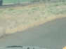 Car Drives Through Highway Crossing Dust Devil