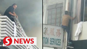 Firemen rescue six people trapped on roof of burning hotel