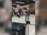 A video posted to Twitter by bystander Vincent Hughes shows a man lifting his now-fiancee into the air as she holds a bouquet of pink flowers.