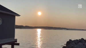 Sunrise and sailboats along the Lake Erie shoreline