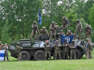 Fighters of the Russian Volunteer Corps and allied group, the Freedom of Russia Legion, stand next to a seized armored personnel carrier during a presentation for the media in northern Ukraine, not far from the Russian border, on May 24, 2023, amid Russian military invasion on Ukraine. Russian nationals fighting on Ukraine's side on May 24 hailed as a "success" a brazen mission to send groups of volunteers across the border into southern Russia and back.