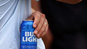 A fan holds a Bud Light beer during day three of the LIV Golf Invitational - DC at Trump National Golf Club on May 28, 2023 in Sterling, Virginia. This is despite the supposed conservative-led boycott of Bud Light products after their collaboration with transgender influencer Dylan Mulvaney.