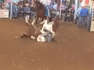 PANIC ensues at rodeo event after horse loses balance and pins rider to the ground