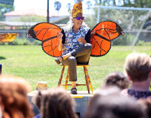 Gateway School Life Lab science teacher Caprice Potter sits in a monarch butterfly “throne” wearing a sunflower crown during a retirement sendoff for her at the Santa Cruz school on Thursday. Potter, has who has been instilling the love of nature, gardening, nutrition and science for 35 years, has worked with more than 1,000 students at Gateway. (Shmuel Thaler - Santa Cruz Sentinel)