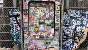 ATM covered in thousands of stickers at historical viewing platform in Lisbon, Portugal