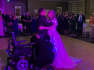 Moment wheelchair-using groom surprises bride by standing for wedding first dance