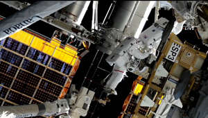 Spacewalkers Installing Roll Out Solar Array At Space Station
