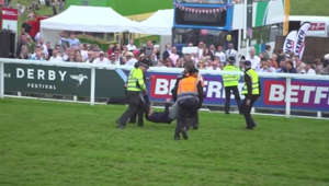 Protesters storm the field at Epsom Derby racecourse