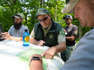 June 5, 2023:  Forest Service worker David Whitmore (center) consults a map with Augusta county emergency management worker Patrick Lam (right) along with Aaron Bennington (left) and Brent Foltz rear. Members of the U.S. Forest Service and Augusta County emergency management work Monday afternoon near an old trail that leads to a crash site. An unresponsive pilot collided into mountainous terrain near the George Washington National Forest Sunday. F-16 fighter jets tried to alert the pilot with flares and traveled at supersonic speeds.