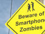 Crossing signs warn of people on phones