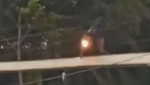 Motorcyclist gets into trouble crossing unstable bridge in storm