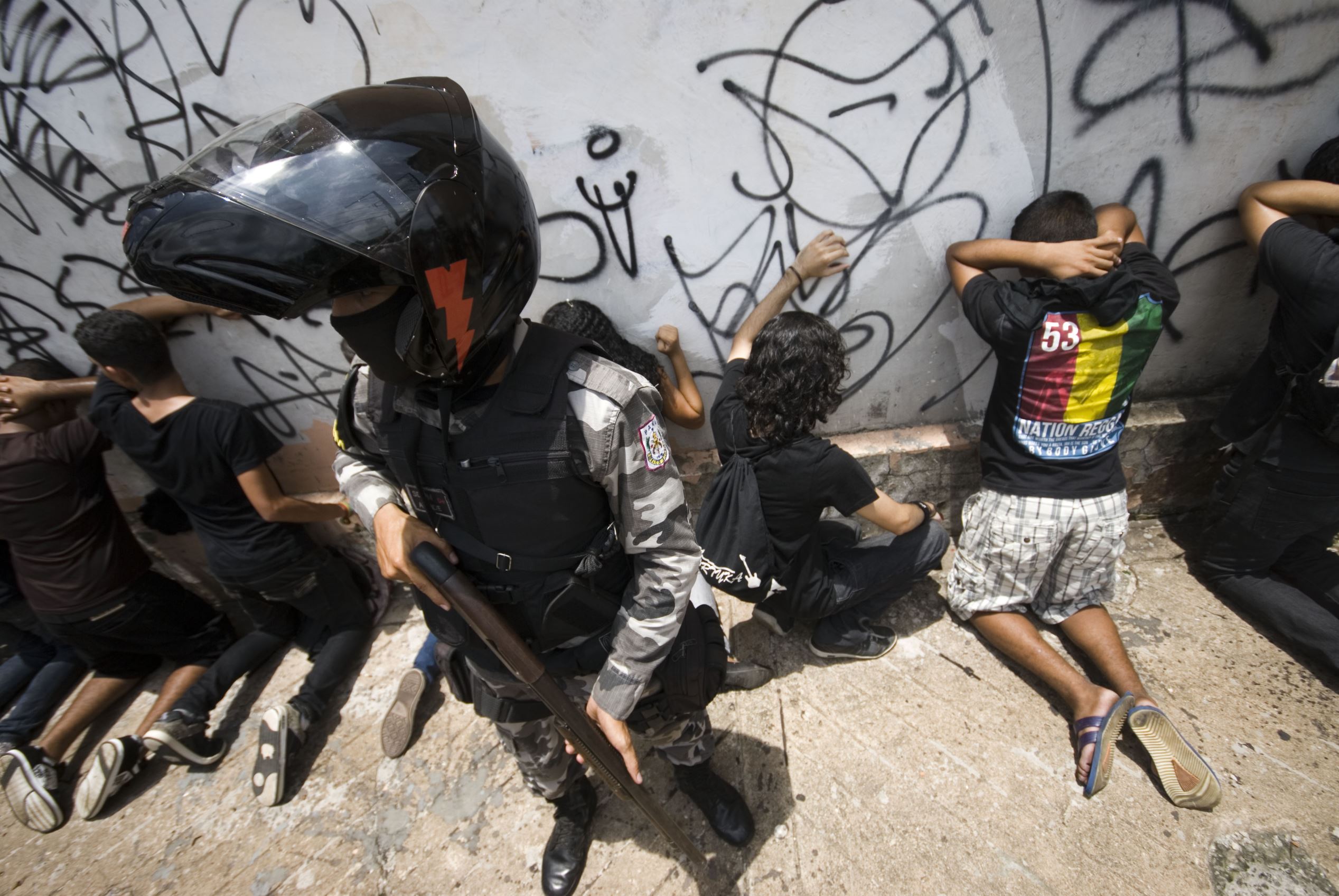 Police stand guard over suspects arrested during Independence Day Protests in Belem.