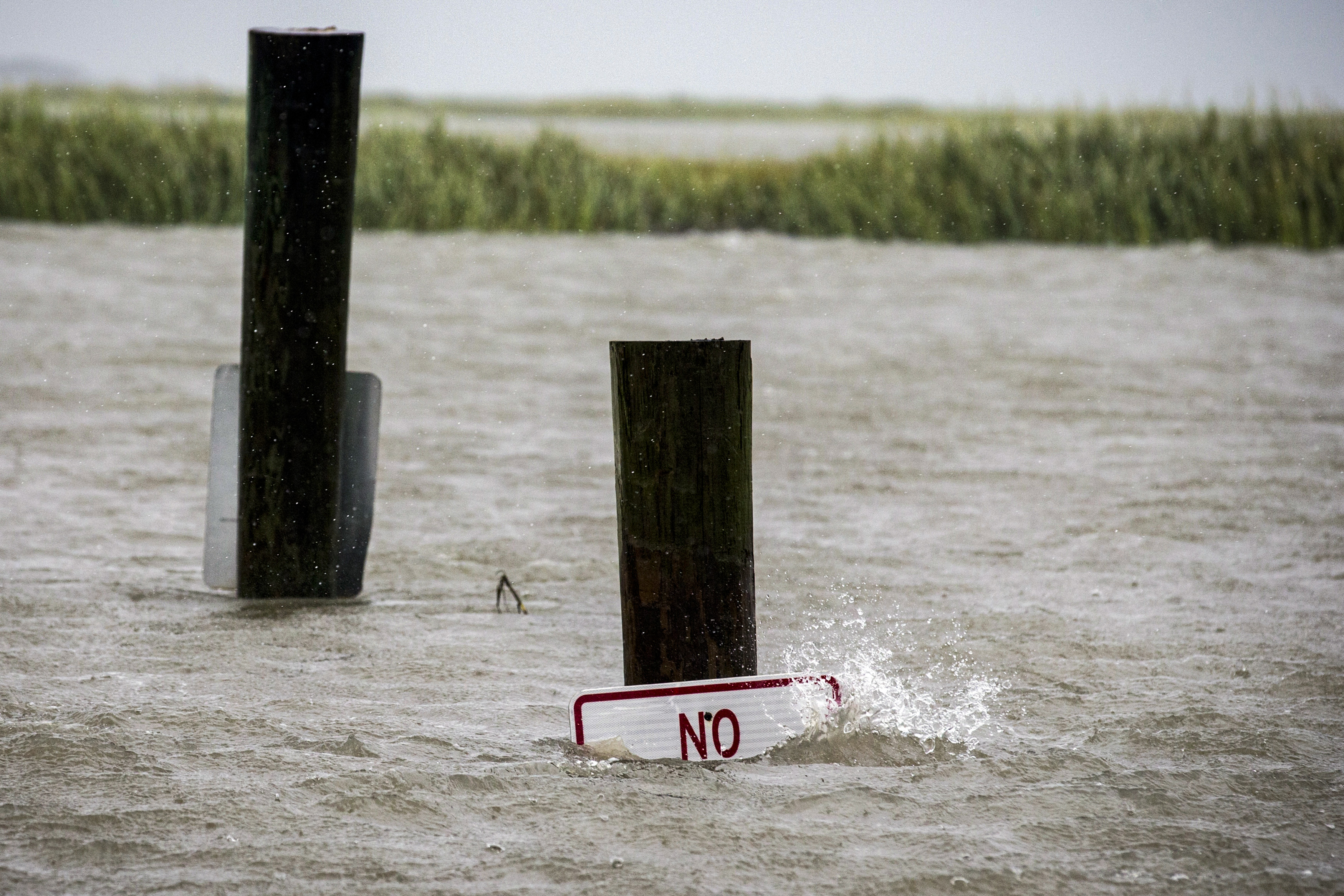 A sign at the Lazaretto Creek boat ramp as is nearly underwater at high tide as Hurricane Dorian makes its way up the east coast, Wednesday, Sept. 4, 2019, toward Tybee Island, Ga. Dorian is forecast to bring storm surge and tropical storm force winds the barrier island.