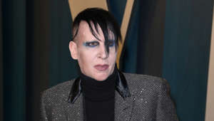 Marilyn Manson wearing a suit and tie