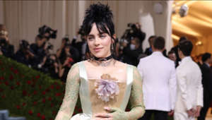 The ‘Ocean Eyes’ singer looked regal posing in a Gucci satin dress that was complete with an ivory satin corset and skirt, as well as mint green lace sleeves. Billie kept her look as eco-friendly as possible by wearing beige platforms made from vegan material.