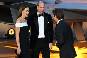 Britain's Catherine, Duchess of Cambridge, (L) and Britain's Prince William, Duke of Cambridge, meet with US actor Tom Cruise on the red carpet upon arrival for the UK premiere of the film "Top Gun: Maverick" at the Leicester Square Gardens, in London, on May 19, 2022. (Photo by JUSTIN TALLIS / AFP) (Photo by JUSTIN TALLIS/AFP via Getty Images)