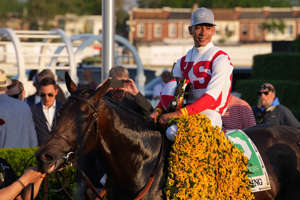 Early Voting, with jockey Jose Ortiz aboard, arrives in the winners circle after winning the 147th Preakness Stakes at Pimlico Race Course.
