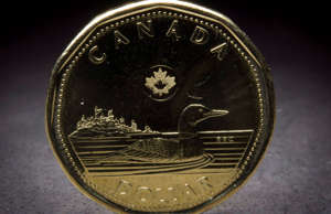 A Canadian loonie is pictured in North Vancouver, B.C. Monday, Jan. 26, 2015.