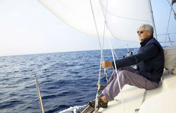 Senior man on a sailboat.