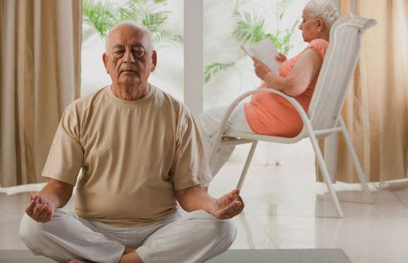 Senior man practicing yoga.