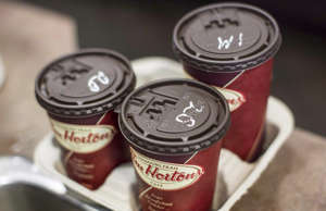Cups of coffee sit on a counter in a Tim Hortons outlet in Oakville, Ont. on Mon...