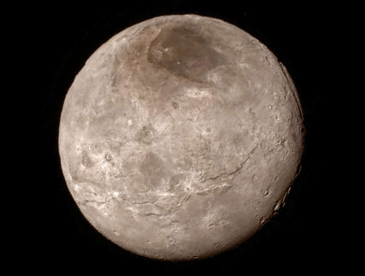 Remarkable new details of Pluto’s largest moon Charon are revealed in this image from New Horizons’ Long Range Reconnaissance Imager (LORRI), taken late on July 13, 2015 from a distance of 289,000 miles (466,000 kilometers). A swath of cliffs and troughs stretches about 600 miles (1,000 kilometers) from left to right, suggesting widespread fracturing of Charon’s crust, likely a result of internal processes. At upper right, along the moon’s curving edge, is a canyon estimated to be 4 to 6 miles (7 to 9 kilometers) deep.