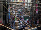 Indians throng a street of a wholesale market on World Population Day in New Delhi, India, Friday, July 11, 2014.
