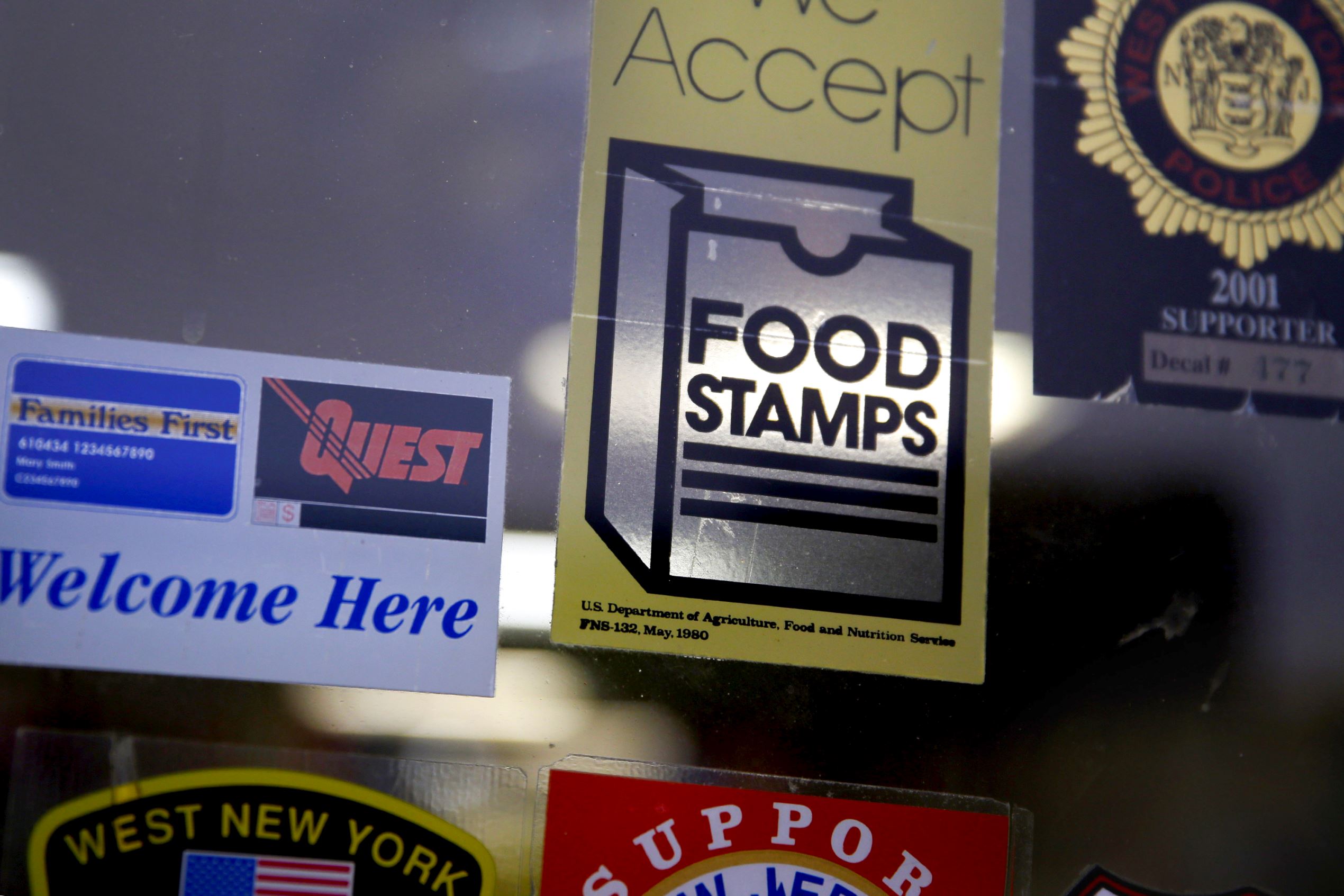 A supermarket displays stickers indicating they accept food stamps in West New York, N.J., Monday, Jan. 12, 2015. New Jersey lawmakers are considering a bill that would require the state to expedite the handling of applications for food stamps.