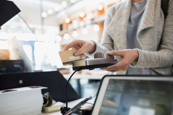 Customer paying at credit card reader in market
