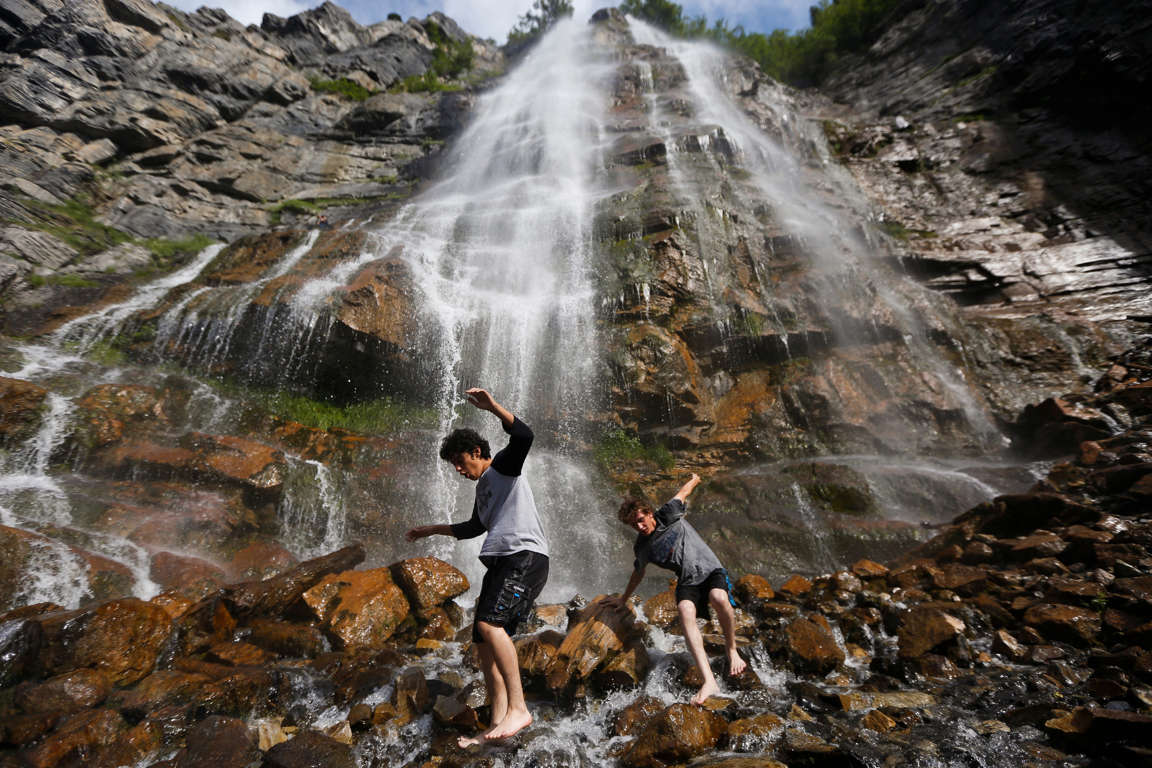 Diego Galvez, 17, and Gaje Robarge, 16, walk near the cool water at Bridal Veil Falls in Provo Canyon, Utah. Provo broke the record for high temperature on June 29, 2015 with a high of 103 degrees, according to the National Weather Service.