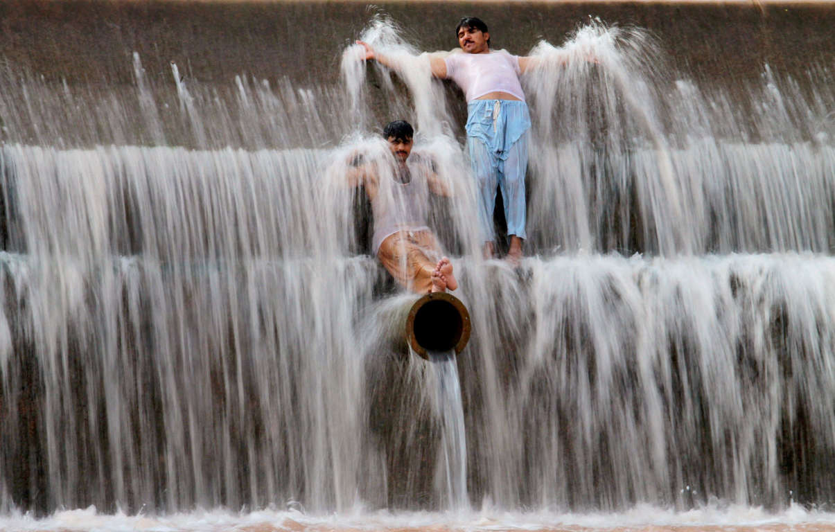 Pakistanis cool off themselves at a river on the outskirts of Islamabad, Pakistan, Sunday, June 21, 2015. Many cities in Pakistan are facing heat wave conditions with temperatures reaching 49 degrees Celsius (120.2 Fahrenheit) in some places.