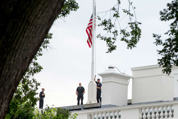 The American flag is lowered to half-staff above the White House in Washington, Tuesday, July 21, 2015, to honor the five U.S. service members who were killed by a gunman in Chattanooga, Tenn. last week.