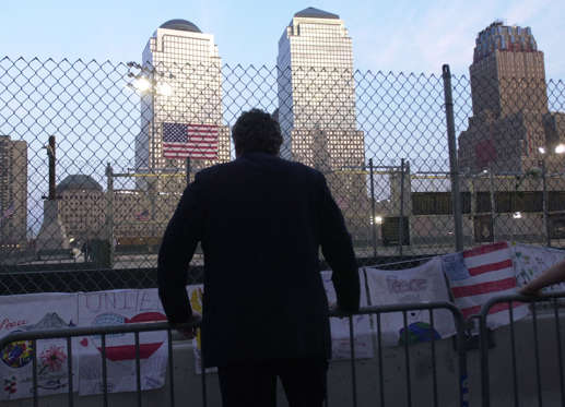 A city worker looks out over the site of Ground Zero in New York ahead of the memorial service to mark the first anniversary of the terrorist attacks on the World Trade Center.