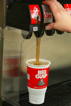 PEMBROKE PINES, FL - JULY 18:  A Diet Coke is poured on a Big Gulp cup at a 7-Eleven store on July 18, 2002 in Pembroke Pines, Florida.  The Big Gulp Car Cup is 32-ounces of cool fountain refreshment that fits in the cup holder of most vehicles.  7-Eleven, Inc., the premiere name and largest chain in the convenience retailing industry, is observing its 75th anniversary in 2002.  (Photo by Joe Raedle/Getty Images)
