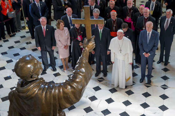Pope Francis pauses in front of a sculpture of Spanish-born Franciscan Friar Junipero Serra in Statuary Hall at the U.S. Capitol in Washington on Sept. 24, 2015.