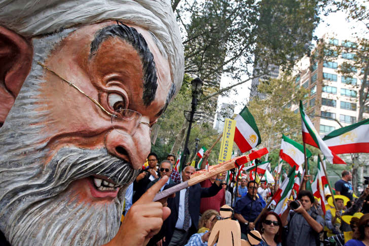 A protester wearing a large mask bearing the likeness of Iranian President Hassan Rouhani attends an anti-Rouhani rally outside United Nations headquarters ahead of the leader&#39;s address to the 70th session of the U.N. General Assembly, Monday, Sept. 28, 2015, in New York.