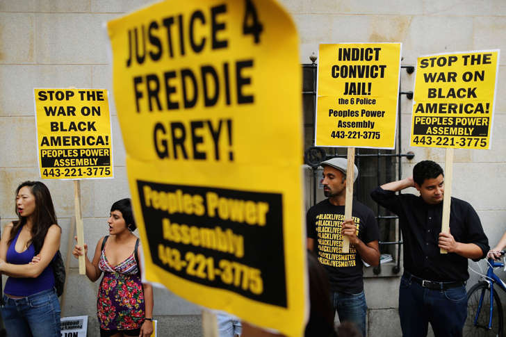 A small and peacful group of demonstrators gather to protest in front of the Baltimore City Circuit Courthouse East where pre-trial hearings will be held for six police officers charged in the death of Freddie Gray September 2, 2015 in Baltimore, Maryland. Earlier this year Gray, 25, suffered a severe spinal cord injury while in police custody and later died. His funeral was followed by rioting, looting and arson.