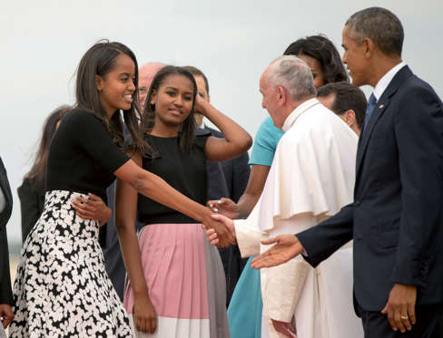 resident Barack Obama, right, and his daughters Malia Obama, left, and Sasha Obama, second from left, greet Pope Francis upon his arrival at Andrews Air Force Base, Md., Tuesday, Sept. 22, 2015.