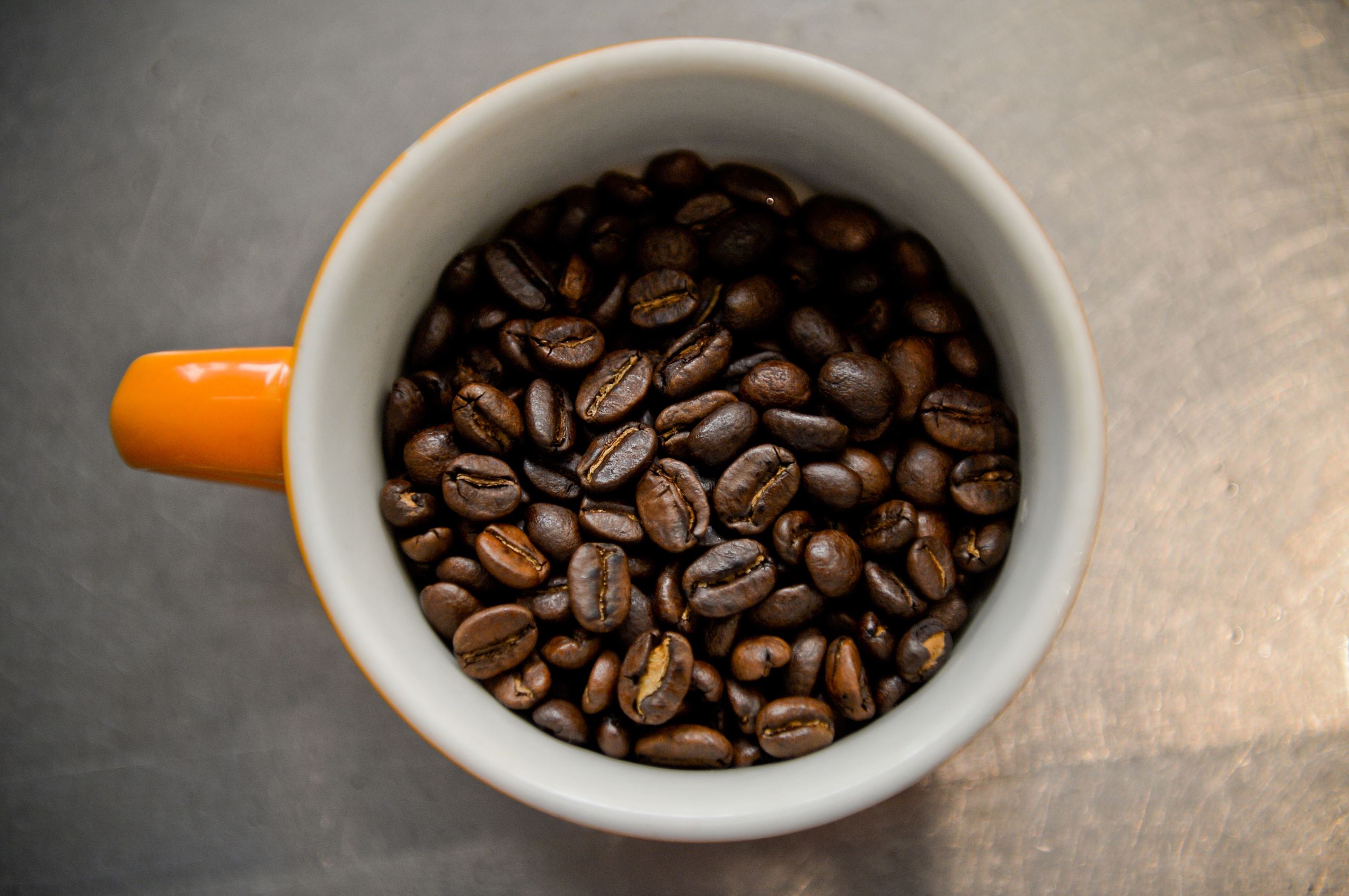 Coffee beans sit in a cup during a class at the Barista Basics Coffee Academy in Sydney, Australia, on Monday, May 25, 2015. Once stereotyped as a land of meat pie-eaters and Foster's lager-swillers, Australia has developed a A$4 billion ($3.2 billion) coffee-drinking market that devours more fresh beans per person than any other country.