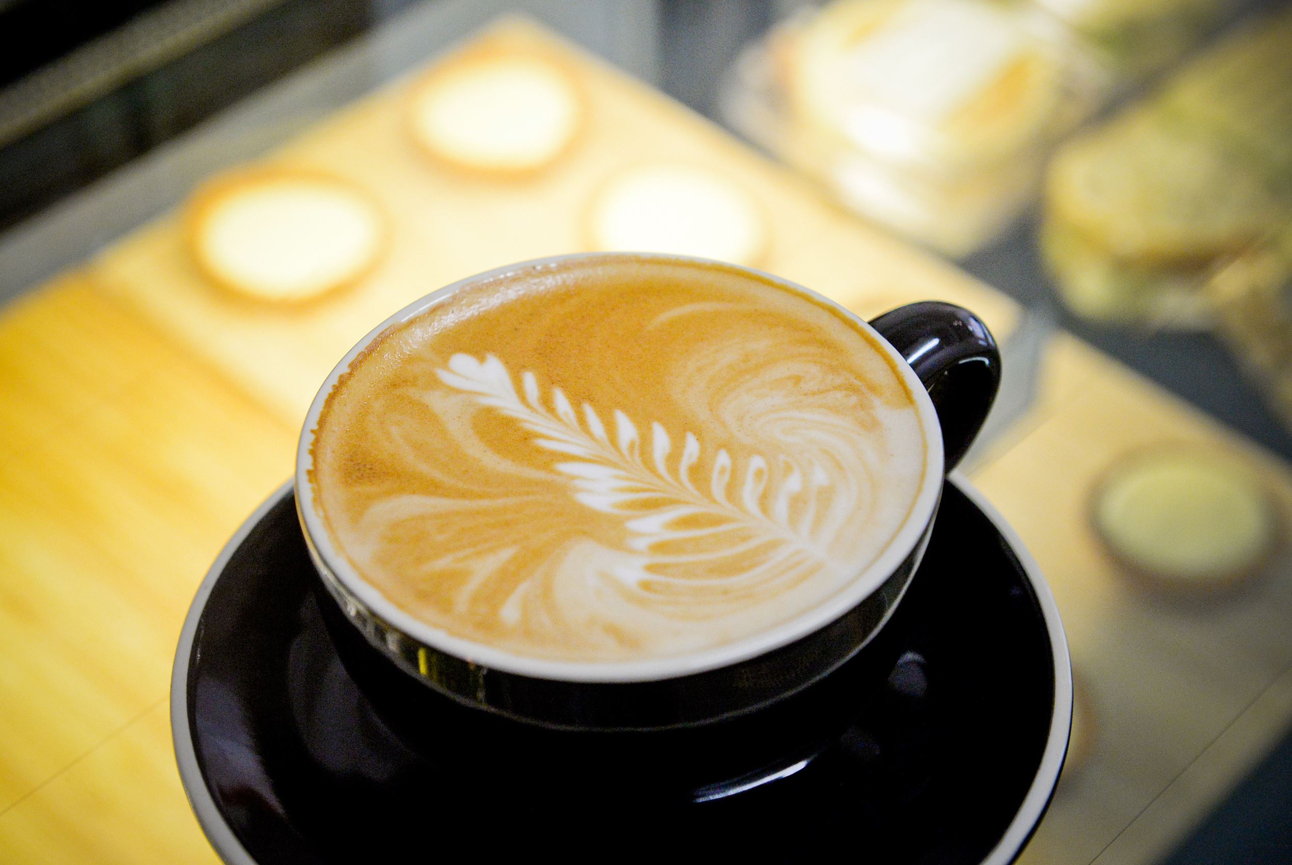 A cup of flat white coffee is arranged for a photograph during a class at the Barista Basics Coffee Academy in Sydney, Australia, on Monday, May 25, 2015. Once stereotyped as a land of meat pie-eaters and Foster's lager-swillers, Australia has developed a A$4 billion ($3.2 billion) coffee-drinking market that devours more fresh beans per person than any other country.