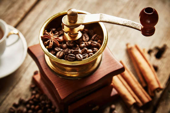 Vintage coffee grinder on wooden background