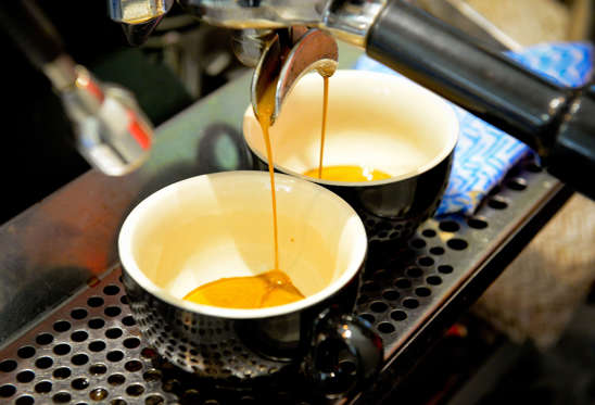 Espresso pours from a machine into cups during a class at the Barista Basics Coffee Academy in Sydney, Australia, on Monday, May 25, 2015. Once stereotyped as a land of meat pie-eaters and Foster's lager-swillers, Australia has developed a A$4 billion ($3.2 billion) coffee-drinking market that devours more fresh beans per person than any other country.